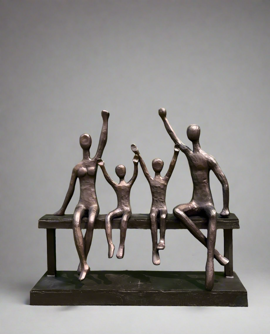 Artistic outdoor sculpture with family figurines in antique gold finish