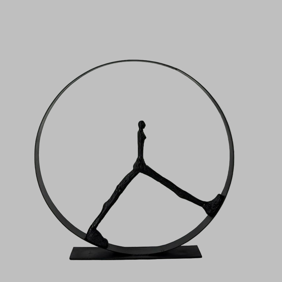 Decorative metal sculpture resembling a Mercedes-Benz logo on a white surface.