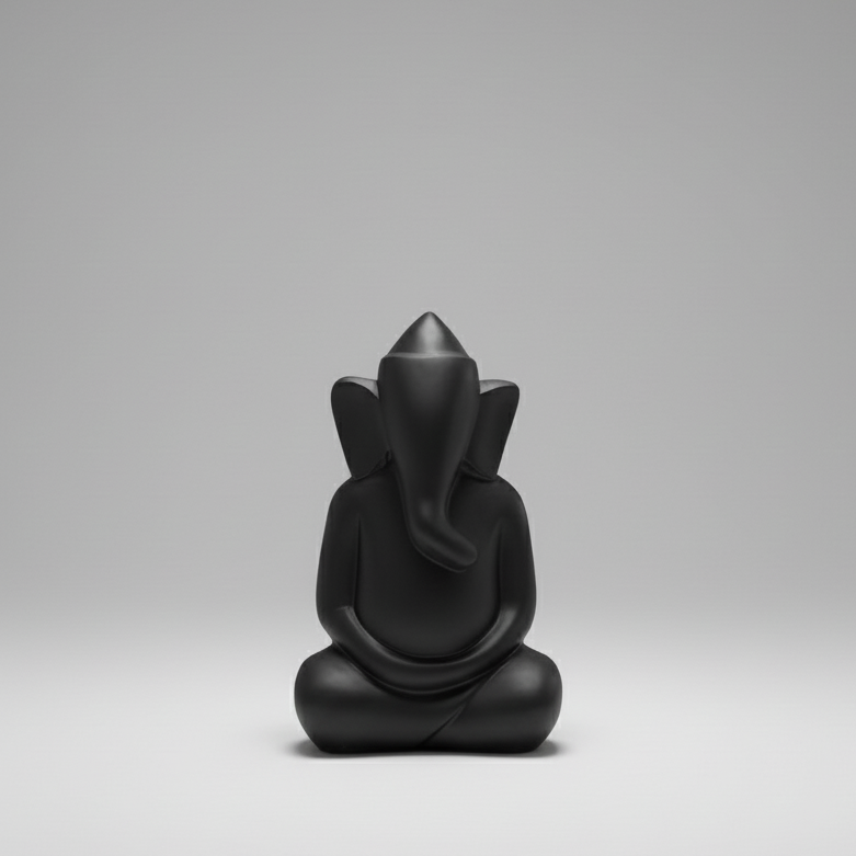 Black figurine of a seated figure on a gray background