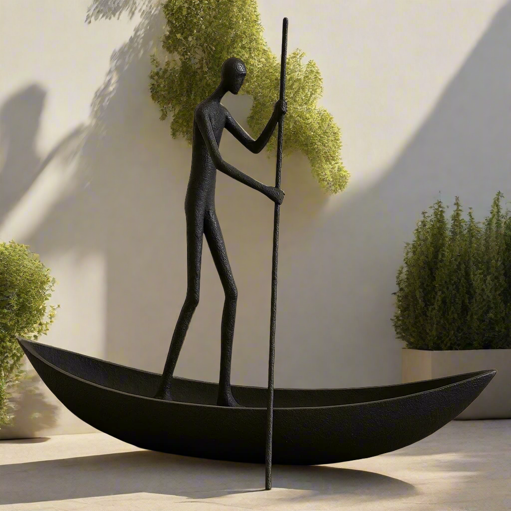 Black sculpture of a person in a boat with a pole against a light wall with greenery