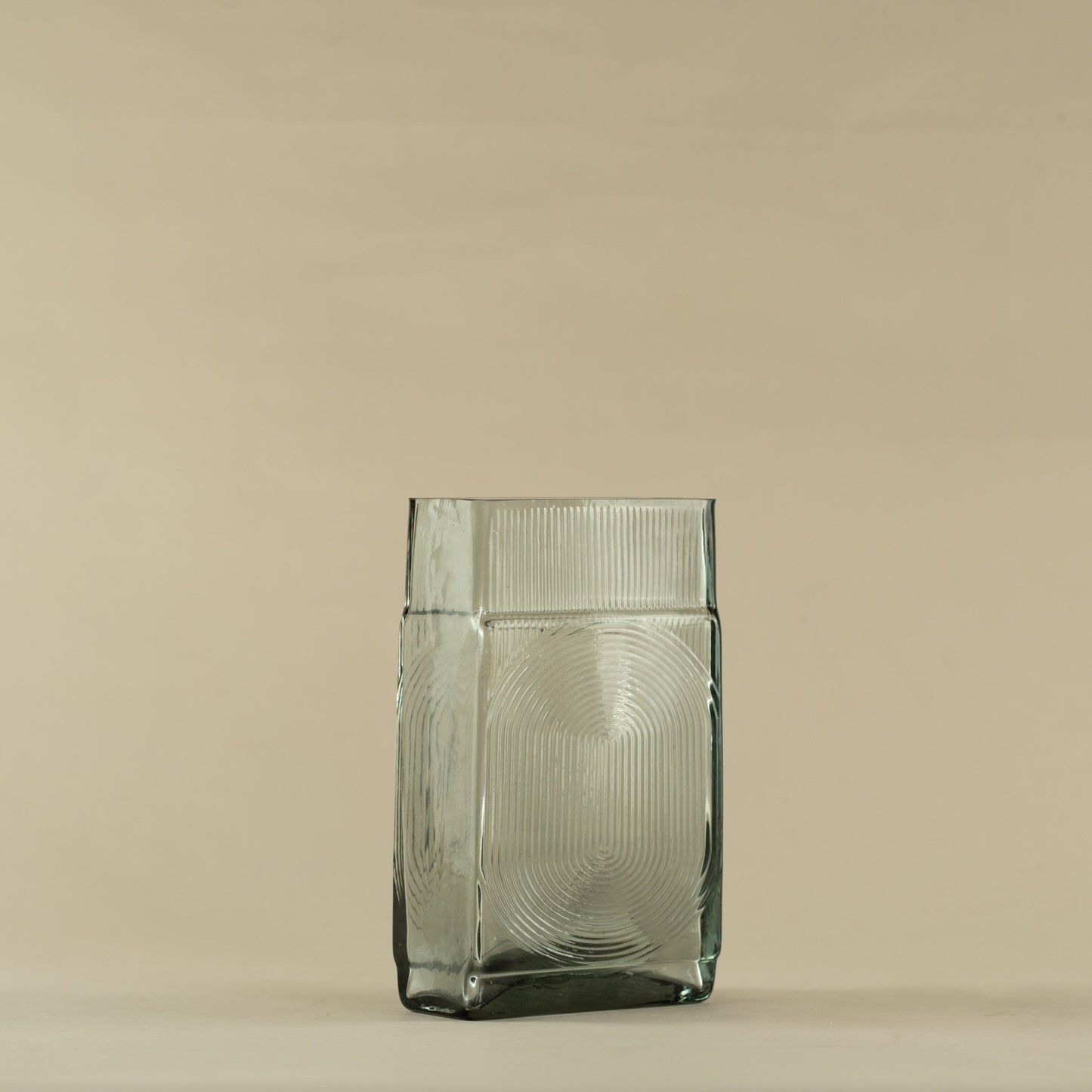 Clear glass vase on a beige background