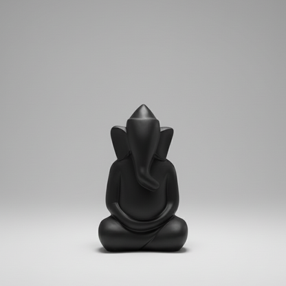 Black figurine of a seated figure on a gray background