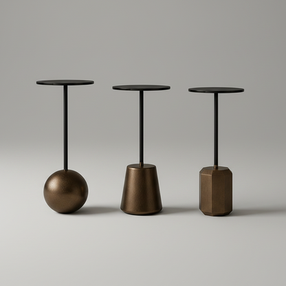 Three minimalist metal side tables with different base shapes on a gray background