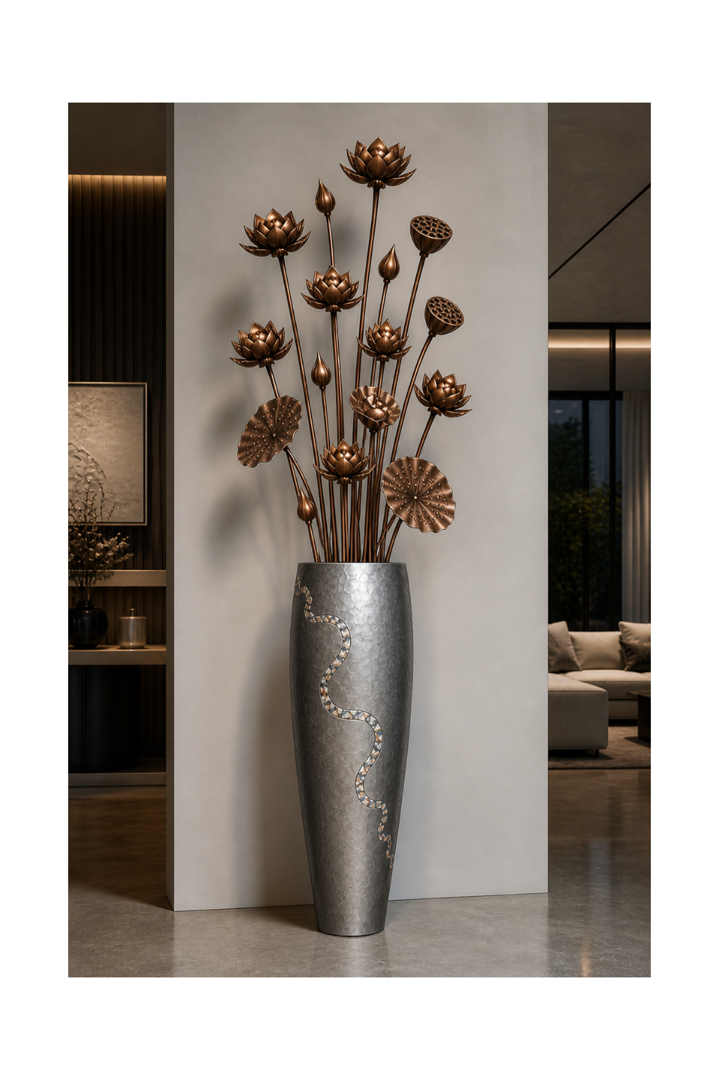 Tall silver vase with decorative elements holding bronze lotus-like sculptures against a modern interior background.