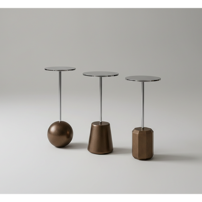 Three metallic side tables with unique bases on a gray background