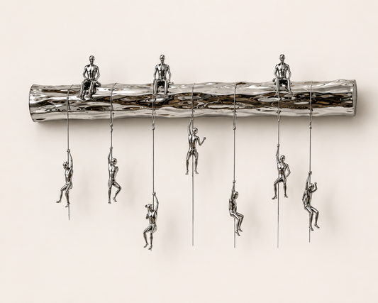 The Climbers contemporary luxury wall sculpture featuring colorful suspended figures climbing a polished metallic beam in a modern interior setting.